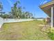 Large grassy backyard with storage shed and privacy fence at 161 Sandhurst Dr, Venice, FL 34293