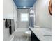Clean bathroom with a white bathtub, herringbone tile walls, and a blue ceiling at 161 Sandhurst Dr, Venice, FL 34293