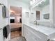 White vanity with marble countertop and view into bedroom at 161 Sandhurst Dr, Venice, FL 34293