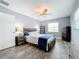 Bright bedroom with wood flooring, a ceiling fan, and built-in shelving at 161 Sandhurst Dr, Venice, FL 34293