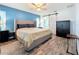 Spacious bedroom with wood-look floors, barn door, and large bed at 161 Sandhurst Dr, Venice, FL 34293