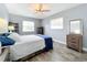 Bedroom with wood-look floors, ceiling fan, and striped bedding at 161 Sandhurst Dr, Venice, FL 34293