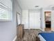 Bedroom with built-in dresser and mirror, and access to another room at 161 Sandhurst Dr, Venice, FL 34293