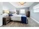 Bedroom with wood-look floors, ceiling fan, and dresser at 161 Sandhurst Dr, Venice, FL 34293