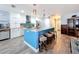 Modern kitchen with white cabinets, blue island, and granite countertops at 161 Sandhurst Dr, Venice, FL 34293