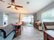 Spacious living room features tile floors, sectional sofa, and access to a screened patio at 161 Sandhurst Dr, Venice, FL 34293