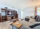 Cozy living room with large sectional sofa and built-in entertainment center at 161 Sandhurst Dr, Venice, FL 34293