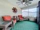 Relaxing screened porch with wicker furniture and a ceiling fan at 161 Sandhurst Dr, Venice, FL 34293