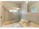 Pink tiled bathroom with shower/tub combo and vanity at 219 Periwinkle Plz, Anna Maria, FL 34216