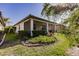 Landscaped backyard with screened patio and lush greenery at 2479 Brassica Dr, North Port, FL 34289