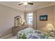 Well-lit bedroom with a queen bed and tropical decor at 2479 Brassica Dr, North Port, FL 34289