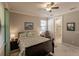 Comfortable bedroom with ensuite bathroom and ceiling fan at 2479 Brassica Dr, North Port, FL 34289