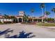 Community center with palm trees, landscaping, and a flag at 2479 Brassica Dr, North Port, FL 34289