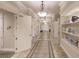 Elegant community hallway with tiled floors and decorative lighting at 2479 Brassica Dr, North Port, FL 34289