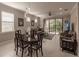 Bright dining room with dark wood table and chairs, adjacent to living room at 2479 Brassica Dr, North Port, FL 34289