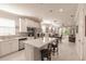 Open concept kitchen with island, stainless steel appliances, and white cabinets at 2479 Brassica Dr, North Port, FL 34289