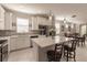 Open concept kitchen with island, stainless steel appliances, and white cabinets at 2479 Brassica Dr, North Port, FL 34289