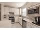 Modern kitchen with white cabinets and stainless steel appliances at 2479 Brassica Dr, North Port, FL 34289