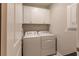 Laundry room with washer, dryer, and cabinets at 2479 Brassica Dr, North Port, FL 34289