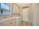 Laundry room with washer, dryer, cabinets, and a utility sink at 2538 Marblehead Dr, Sarasota, FL 34231