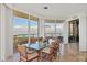 Bright dining room with glass table and wicker chairs, offering stunning water views at 3060 Grand Bay Blvd # 162, Longboat Key, FL 34228