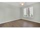 Bright, airy bedroom featuring wood floors, a ceiling fan, and a window letting in natural light at 4178 Central Sarasota Pkwy # 316, Sarasota, FL 34238