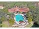 Aerial view of a large community pool featuring ample seating surrounded by lush landscaping and palm trees at 4178 Central Sarasota Pkwy # 316, Sarasota, FL 34238