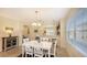 Bright dining area with white table, chairs, and view into kitchen at 6432 Autumn Woods Way, Sarasota, FL 34243