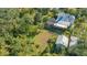 Mature landscaping surrounds this house with a screened porch at 2525 Ashton Rd, Sarasota, FL 34231
