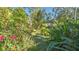 Lush backyard with tropical plants and flowers at 2525 Ashton Rd, Sarasota, FL 34231