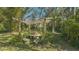 Stone patio and pergola nestled in the garden at 2525 Ashton Rd, Sarasota, FL 34231