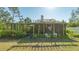 Spacious backyard with a screened porch and pergola at 2525 Ashton Rd, Sarasota, FL 34231