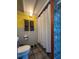 Clean bathroom with shower, glass block feature, and gray tile at 2525 Ashton Rd, Sarasota, FL 34231