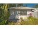 Front entrance with yellow chairs and flowers at 2525 Ashton Rd, Sarasota, FL 34231