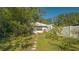 White bungalow with green lawn and fence at 2525 Ashton Rd, Sarasota, FL 34231