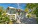 White house with sunlit side yard, showing a white picket fence and landscaping at 2525 Ashton Rd, Sarasota, FL 34231