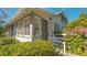Quaint house entrance with white exterior, landscaping, and white railing at 2525 Ashton Rd, Sarasota, FL 34231