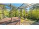 Lovely screened-in patio with hot tub, lush foliage, and seating at 2525 Ashton Rd, Sarasota, FL 34231