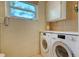 Laundry area with washer, dryer, and built-in storage at 2525 Ashton Rd, Sarasota, FL 34231