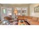 Living room boasts a large sectional sofa, mid-century modern decor, and hardwood floors at 2525 Ashton Rd, Sarasota, FL 34231