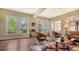 Bright living room with hardwood floors, comfortable seating, and large windows at 2525 Ashton Rd, Sarasota, FL 34231