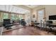 Sunlit office space with hardwood floors, built-in shelving, and comfortable seating at 2525 Ashton Rd, Sarasota, FL 34231