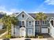 Two-story house with blue siding, white trim, and palm trees at 5560 Rosehill Rd # 201, Sarasota, FL 34233