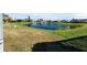 Peaceful backyard view of a pond and neighborhood homes at 5755 Carriage Dr, Sarasota, FL 34243