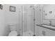 Clean bathroom with toilet, sink, and walk-in shower at 5755 Carriage Dr, Sarasota, FL 34243