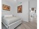 Main bedroom with a queen bed, artwork, and access to the bathroom at 5755 Carriage Dr, Sarasota, FL 34243