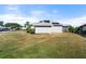 Rear view of home showcasing solar panels at 5755 Carriage Dr, Sarasota, FL 34243