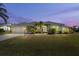 Attractive single-story home with a landscaped lawn and attached garage at 5755 Carriage Dr, Sarasota, FL 34243