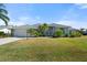 Well-maintained single-story house with a lush green lawn at 5755 Carriage Dr, Sarasota, FL 34243