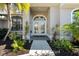 Elegant front entry with double doors and sidelights at 5755 Carriage Dr, Sarasota, FL 34243